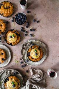 Spongy moist burst Vegan gluten-free Peanut Butter Blueberry Cake recipe; infused with citrus lemon and vanilla in a millet and rice confectionary. Edward Daniel ©.