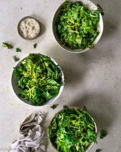 Vibrant earthy nutty crispy kale with citrus lemon, olive oil, sea salt and roasted sesame seeds; Kale Chips. Edward Daniel ©.