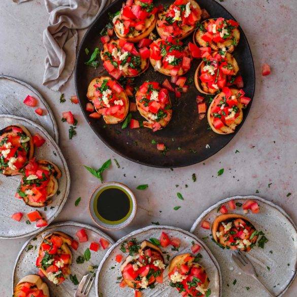 Lashings of diced tomatoes topped with basil and garlic, drizzled with olive oil and balsamic vinegar on griddled bread; vegan Tomato Bruschetta; Italian cuisine. Edward Daniel ©.