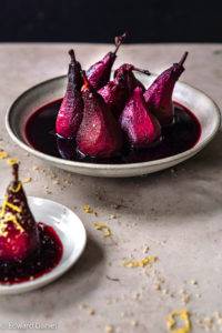 Pears slowly tenderised in caramelised red wine with aromatic earthy cloves, cinnamon and Star anise, vegan Poached pears in Red Wine recipe. Edward Daniel ©.