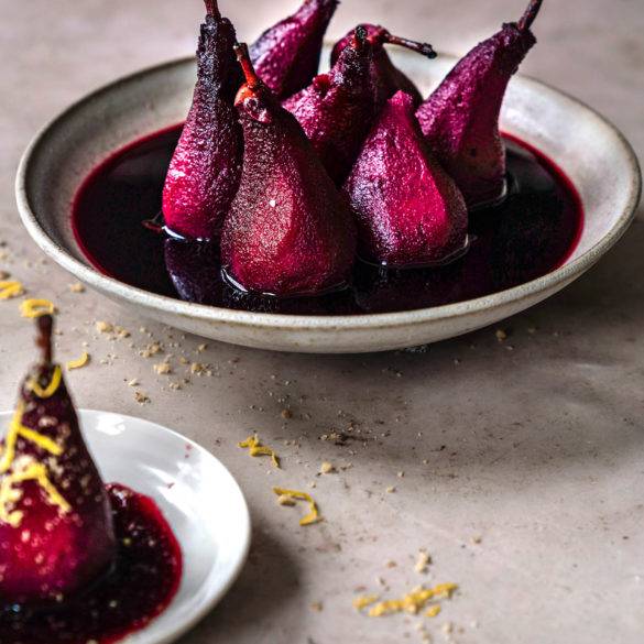 Pears slowly tenderised in caramelised red wine with aromatic earthy cloves, cinnamon and Star anise, vegan Poached pears in Red Wine recipe. Edward Daniel ©.