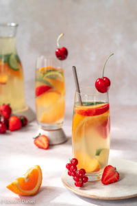 Macerated fruity Sangria cocktail classic with wine and chopped citrus orange, bitter cucumber and juicy sweet strawberries; vegan Sangria recipe. Edward Daniel ©.