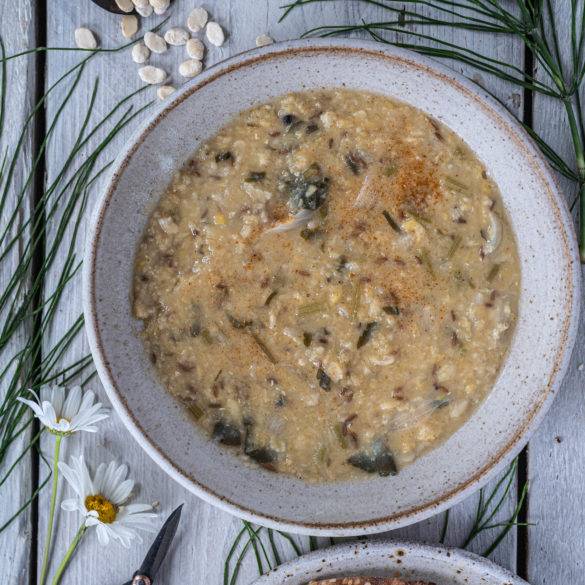 Hearty fava beans lentil soup infused with a dash of cumin, garlic, cayenne pepper and topped with parsley; Ful Medames.