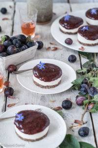 Freshly picked tart ripe damsons over a creamy cacao sesame filling on a mulberry pecan biscuit; Damson Cheesecake.