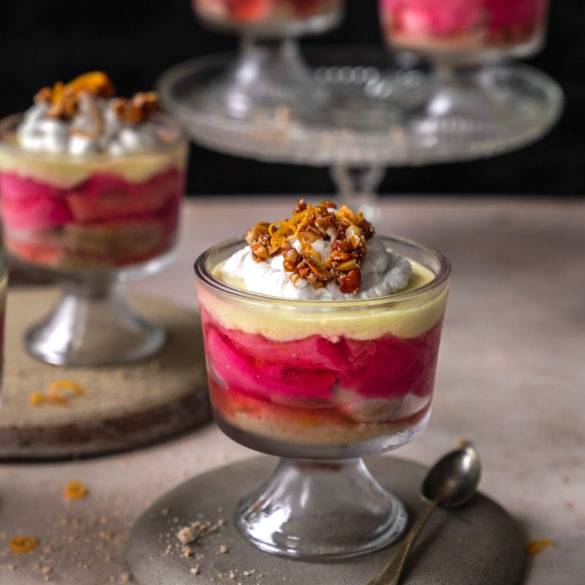 Grenadine poached rhubarb, madeira-soaked sponge, zesty orange, saffron ginger custard, cream topped with caramelised nuts; vegan gluten-free Rhubarb Trifle recipe, British cuisine. Edward Daniel ©.