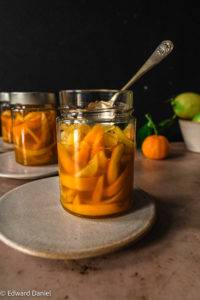 Homemade delicate sweet scented tangy peel slices soaked in citrus caramelised syrup; vegan Candied Orange and Lemon Peel recipe. Edward Daniel ©.