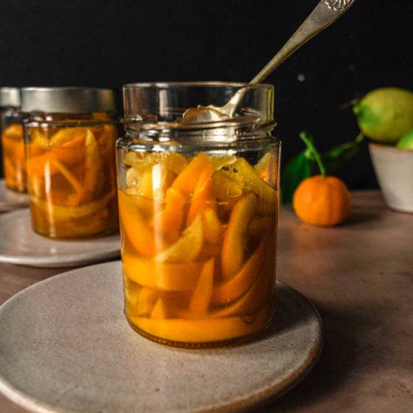 Homemade delicate sweet scented tangy peel slices soaked in citrus caramelised syrup; vegan Candied Orange and Lemon Peel recipe. Edward Daniel ©.