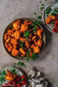 Cauliflower rubbed in rose sweet paprika, kicking cayenne pepper, minty oregano, sun-kissed sundried tomatoes and nutty sesame seeds slowly dehydrated to intensify flavours; vegan gluten-free Raw Cauliflower Buffalo Wings; paleo too. Edward Daniel ©.