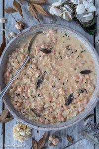 Hearty Tuscan beans stewed in wine and almond cream with a hint of sage topped off with sesame seeds and nutritional yeast; Tuscan Bean Stew.