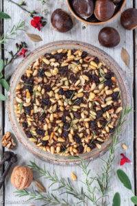 Marsala soaked raisins, pine nuts, walnuts and rosemary with a drizzle of olive oil to make a moist unleavened Tuscan Chestnut Cake; Castagnaccio.