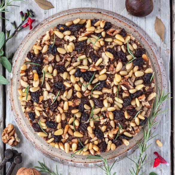 Marsala soaked raisins, pine nuts, walnuts and rosemary with a drizzle of olive oil to make a moist unleavened Tuscan Chestnut Cake; Castagnaccio.