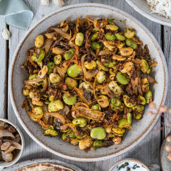 Dry Broad Bean Flatlay Shelled Dry Broad Bean Curry flavoured with curry leaves, mustard and cumin seeds, fresh ginger and lime juice.