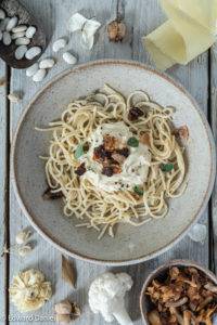 Vegan Carbonara made with creamy butter beans and delicate cauliflower florets with marinaded mushroom pancetta and coconut bacon.