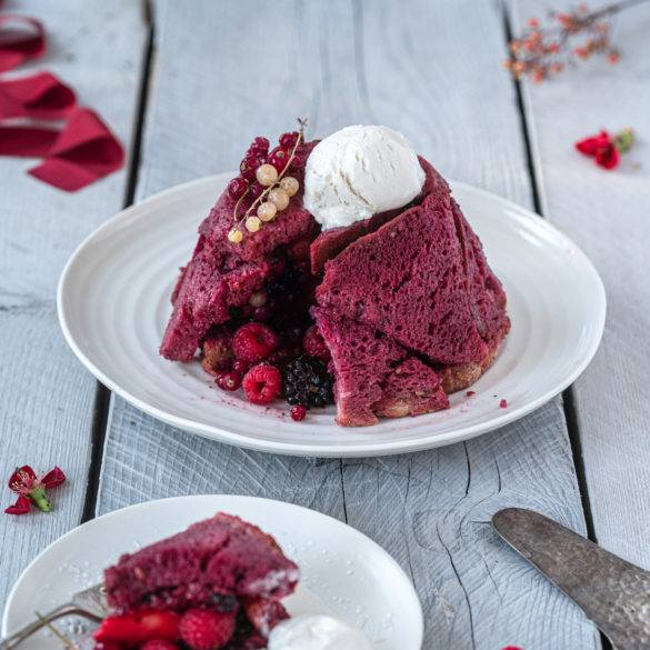 Summer Pudding with lashings of tangy burst redcurrants, raspberries, blackberries and strawberries in wine infused with cinnamon.