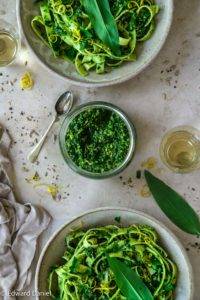 Crushed wild garlic scattered with peppery basil, bitter sunflower seeds, nutritional yeast, olive oil and salt; vegan Wild Garlic Pesto recipe, a raw condiment. Edward Daniel ©.