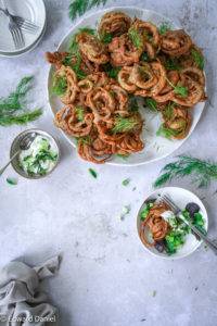 Crisp bite-sized Onion Bhaji infused with pomegranate seeds, mango, coriander, cumin, garlic, ginger and a touch of citrus lemon juice; vegan gluten-free Onion Bhaji recipe. Edward Daniel ©.