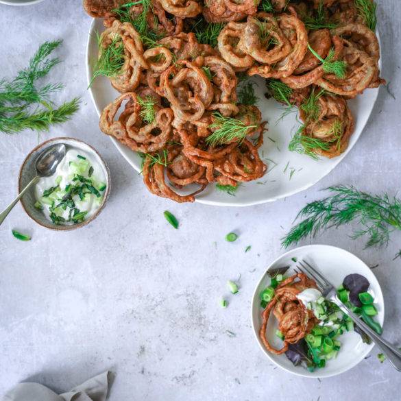 Crisp bite-sized Onion Bhaji infused with pomegranate seeds, mango, coriander, cumin, garlic, ginger and a touch of citrus lemon juice; vegan gluten-free Onion Bhaji recipe. Edward Daniel ©.