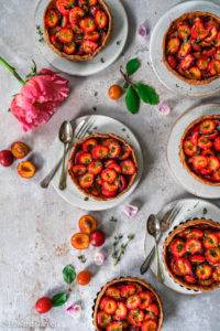 Succulent tangy tart vegan gluten-free Plum Pie recipe; flavoured with citrus lemon and earthy floral thyme on a nutty amaranth pastry base. Edward Daniel ©.